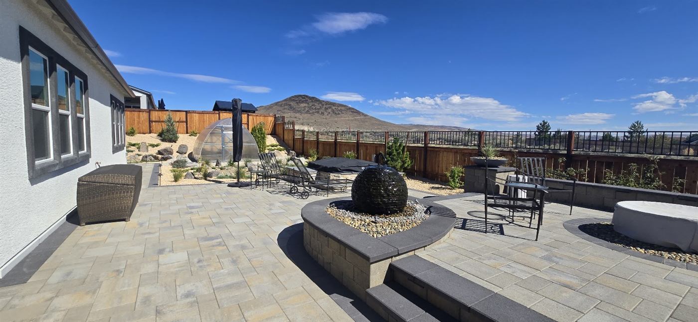 Stained wood fence bordering a finished stone patio